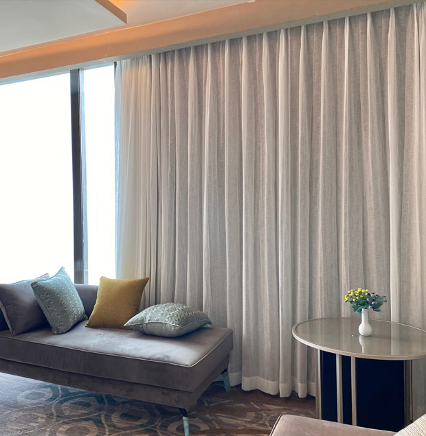 parted-pleat-curtains-behind-couch-and-stool